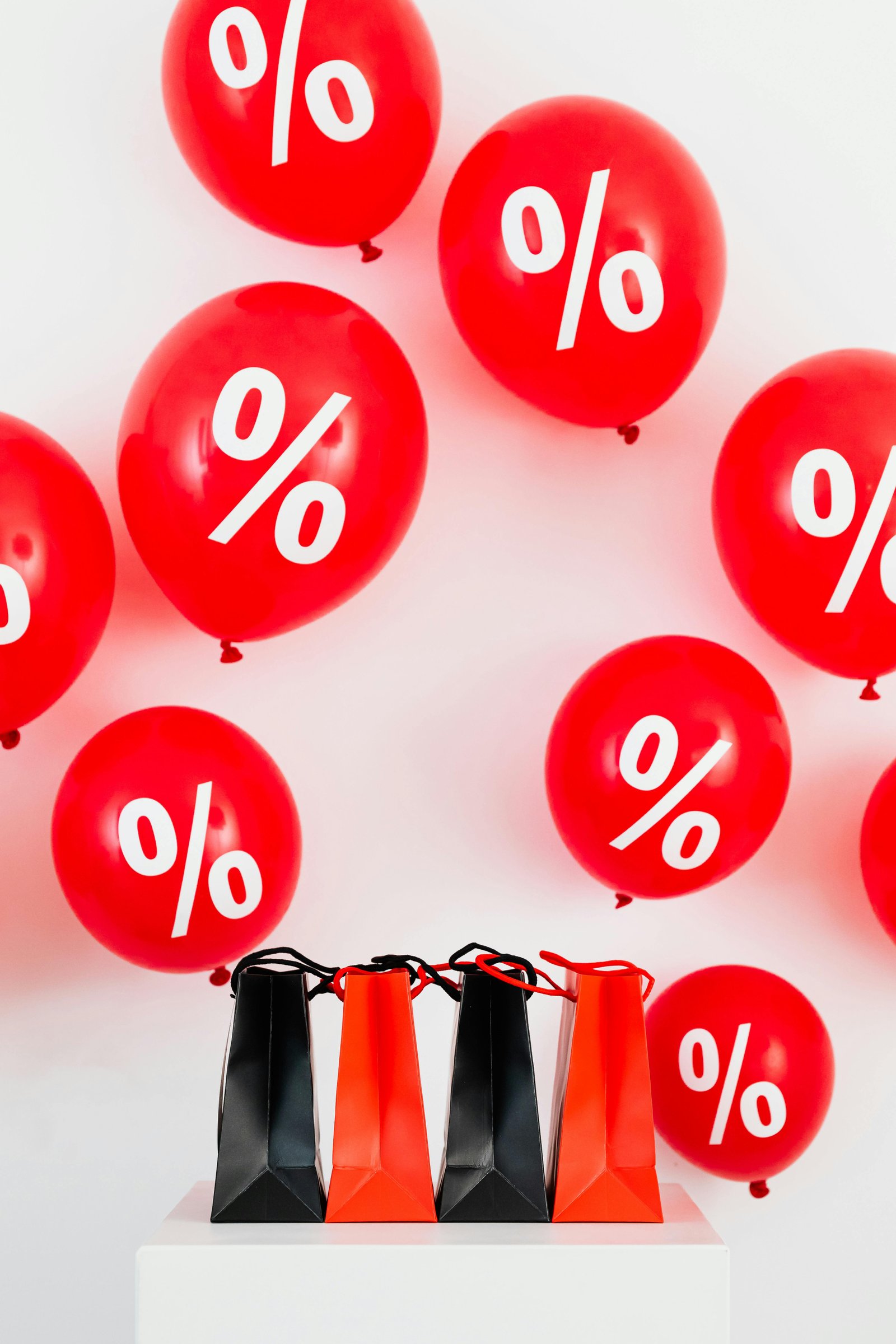 Red balloons with percent symbols and shopping bags