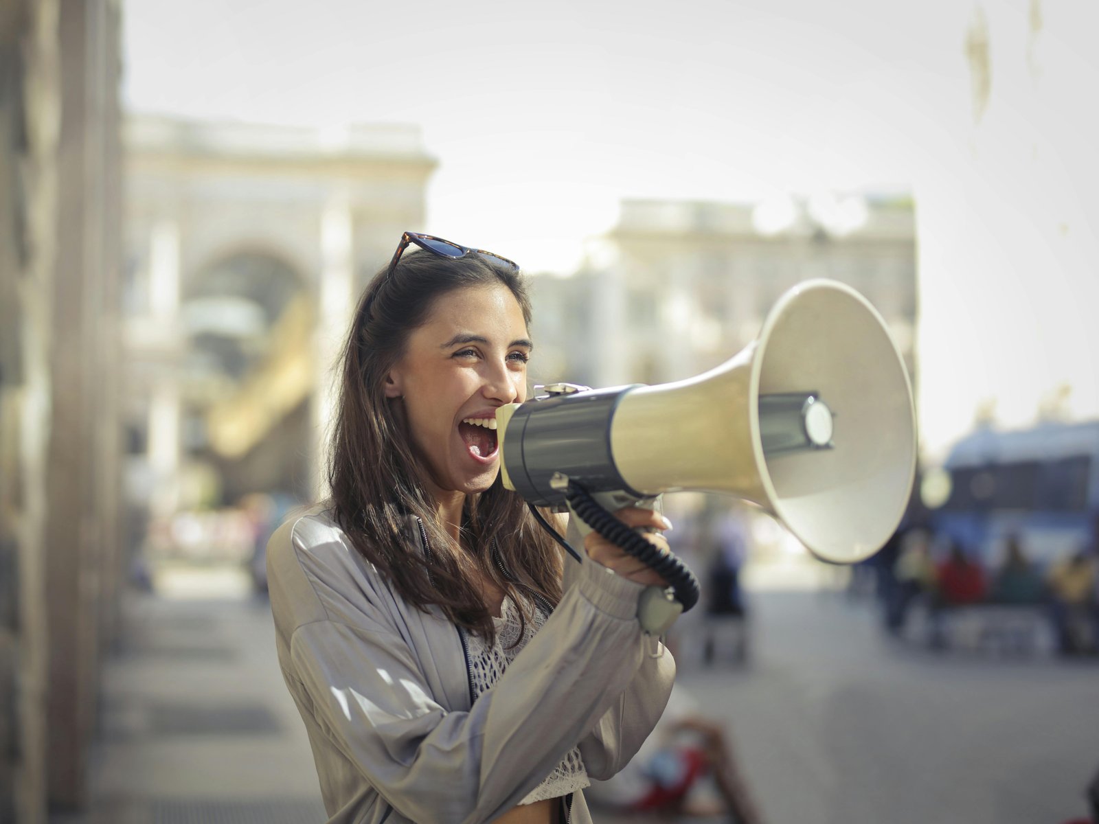 Woman announcing with a megaphone outdoors