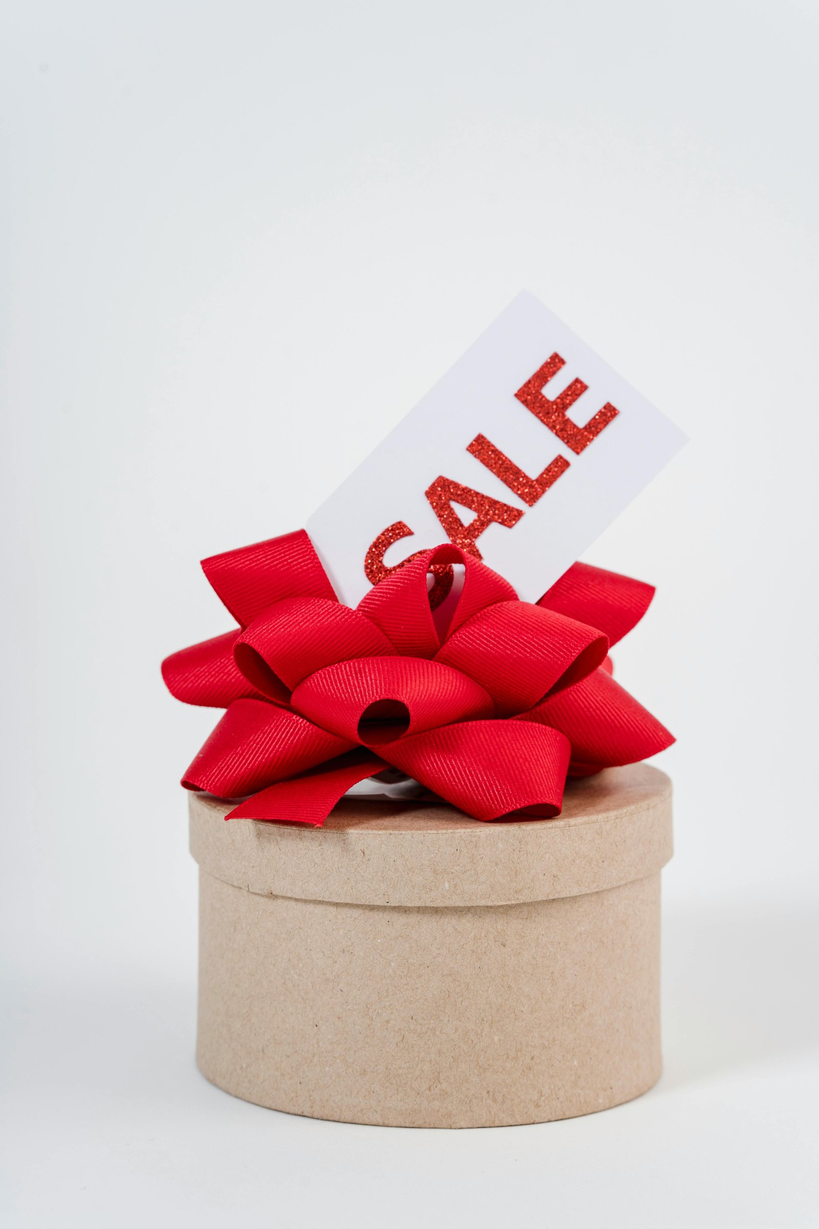 Gift box with red ribbon and SALE tag